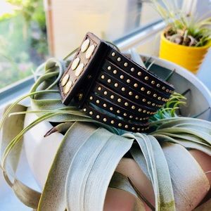 Leather cuff with gold studded clasp detail